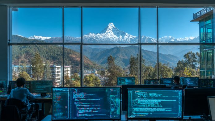 Futuristic IT office in Pokhara with a view of the Himalayas - PokharaHost Tech Hub 2026.